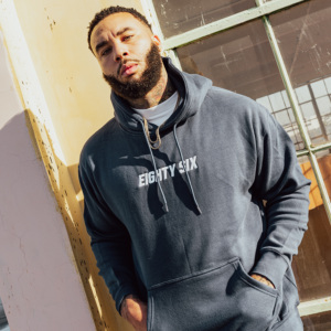 A man with beard waering a eighty six brand hoodie